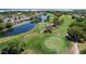 Scenic golf course view featuring tranquil ponds and lush greenery, providing a challenging and visually appealing experience for golfers at 10033 Hidden Dunes Ln, Orlando, FL 32832