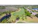 Scenic golf course view surrounded by lush trees and a serene pond, offering a peaceful and challenging play for golf enthusiasts at 10033 Hidden Dunes Ln, Orlando, FL 32832