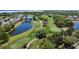 Aerial view of a stunning golf course with picturesque ponds and lush trees, offering a challenging and scenic experience for golfers at 10033 Hidden Dunes Ln, Orlando, FL 32832