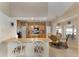 Bright and airy kitchen with breakfast bar, glass table, and light wood cabinetry at 10033 Hidden Dunes Ln, Orlando, FL 32832