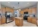 Spacious kitchen with stainless steel appliances, center island, and ample cabinet space at 10033 Hidden Dunes Ln, Orlando, FL 32832