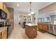 Bright kitchen with island, stainless steel appliances, tile floor and eat-in breakfast nook with bay windows at 10033 Hidden Dunes Ln, Orlando, FL 32832