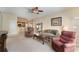 Cozy living room with plush seating, ceiling fan, and open access to the breakfast bar at 10033 Hidden Dunes Ln, Orlando, FL 32832