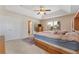 Spacious main bedroom with light carpet, ceiling fan and a view into the bathroom at 10033 Hidden Dunes Ln, Orlando, FL 32832