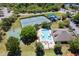 Aerial view of community tennis courts, a swimming pool, basketball court, and playground offering diverse recreational activities at 10033 Hidden Dunes Ln, Orlando, FL 32832