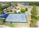 Aerial view of community tennis courts, a basketball court, playground and baseball field offering various recreational activities for residents at 10033 Hidden Dunes Ln, Orlando, FL 32832