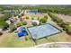 Community tennis courts, basketball court, playground and pool surrounded by lush greenery, perfect for active recreation and leisure at 10033 Hidden Dunes Ln, Orlando, FL 32832