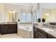 Bright bathroom with dual sinks, granite countertops, and a large soaking tub at 1004 Castle Pines Ct, Reunion, FL 34747