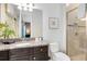 Bright bathroom with granite countertops, a sink, and a glass-enclosed shower at 1004 Castle Pines Ct, Reunion, FL 34747