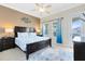 Bedroom with a King bed and blue accents at 1004 Castle Pines Ct, Reunion, FL 34747