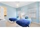Whimsical bedroom designed with light blue walls, snowflake accents, and twin beds at 1004 Castle Pines Ct, Reunion, FL 34747