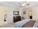 Bedroom with a dresser, television, and chair creating a relaxing space at 1004 Castle Pines Ct, Reunion, FL 34747