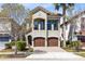 Inviting two-story home boasts a charming balcony and a two-car garage for convenient parking at 1004 Castle Pines Ct, Reunion, FL 34747