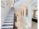 Inviting foyer with staircase, tiled flooring, and elegant decor leading to the bedrooms at 1004 Castle Pines Ct, Reunion, FL 34747