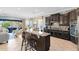 Gourmet kitchen with granite counters, breakfast bar, stainless appliances, and adjacent living area at 1004 Castle Pines Ct, Reunion, FL 34747