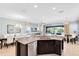 Open-concept kitchen featuring granite counters, stainless appliances, and seamless flow to dining and living spaces at 1004 Castle Pines Ct, Reunion, FL 34747