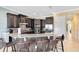 Well-equipped kitchen featuring granite counters, dark wood cabinets, and a convenient breakfast bar at 1004 Castle Pines Ct, Reunion, FL 34747