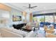 Light-filled living room with comfortable seating, a ceiling fan, and a sliding glass door to outside at 1004 Castle Pines Ct, Reunion, FL 34747