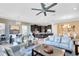 Spacious living area with modern decor, blending seamlessly into the kitchen and dining spaces at 1004 Castle Pines Ct, Reunion, FL 34747