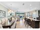 Expansive living area with an open layout, seamlessly connecting the dining and kitchen areas for easy living at 1004 Castle Pines Ct, Reunion, FL 34747