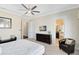 Spacious main bedroom with neutral tones, a cozy chair, and an adjoining bathroom at 1004 Castle Pines Ct, Reunion, FL 34747