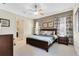 Serene primary bedroom suite with ensuite bathroom, soft carpet, and natural light at 1004 Castle Pines Ct, Reunion, FL 34747
