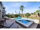 Inviting pool and spa area with lounge chairs, dining set, and serene backyard views at 1004 Castle Pines Ct, Reunion, FL 34747