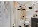 Bathroom with a shower and dark vanity cabinet at 102 Ethan Ave, Davenport, FL 33897