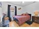 Bedroom featuring an orange bedspread, artwork and a large window at 102 Ethan Ave, Davenport, FL 33897
