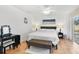 Bedroom featuring a queen bed, ceiling fan, a vanity, and a sliding glass door with pool view at 102 Ethan Ave, Davenport, FL 33897