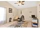 Bright bedroom featuring neutral walls, tiled floors, and ceiling fan, creating a versatile space for living at 102 Ethan Ave, Davenport, FL 33897