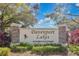 Elegant stone community sign for Davenport Lakes, a deed-restricted community, nestled amongst mature trees at 102 Ethan Ave, Davenport, FL 33897