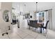 Charming dining room featuring dark wood table, seating for six, modern lighting, and tile flooring at 102 Ethan Ave, Davenport, FL 33897