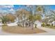 Charming single-story home with well-manicured lawn, mature trees, and inviting curb appeal, creating a welcoming atmosphere at 102 Ethan Ave, Davenport, FL 33897