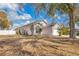 Side view of home showing mature landscaping and neutral colored exterior with white trim at 102 Ethan Ave, Davenport, FL 33897