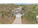 An aerial view of a home with a manicured front yard, a driveway, and an attached two-car garage at 102 Ethan Ave, Davenport, FL 33897