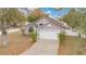 A charming home with a manicured front yard, a driveway, and an attached two-car garage at 102 Ethan Ave, Davenport, FL 33897