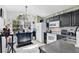 Bright kitchen featuring an island, white appliances, tile floors, and a large window at 102 Ethan Ave, Davenport, FL 33897
