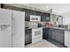 Well-lit kitchen featuring white appliances, tile floors, and sleek countertops at 102 Ethan Ave, Davenport, FL 33897