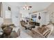 Inviting living room features tile floors, neutral paint, several couches, and a ceiling fan at 102 Ethan Ave, Davenport, FL 33897