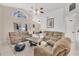 Bright living room features tile floors, neutral paint, multiple couches, ceiling fan, and natural light at 102 Ethan Ave, Davenport, FL 33897