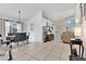 Open floor plan with living room and dining area featuring tile floors and neutral paint throughout at 102 Ethan Ave, Davenport, FL 33897