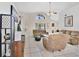 Spacious living room featuring neutral paint, tile floors, multiple couches, and ceiling fan at 102 Ethan Ave, Davenport, FL 33897