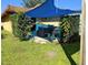 Backyard patio with a blue tarp and a hot tub at 10223 Marco Polo Dr, Orlando, FL 32821