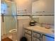 Bathroom featuring a walk-in shower with glass door and tiled walls at 10223 Marco Polo Dr, Orlando, FL 32821
