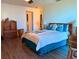 Cozy bedroom with wood floors, a comfortable bed, and natural light from the window at 10223 Marco Polo Dr, Orlando, FL 32821