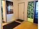 View of the home's foyer with tile flooring, neutral paint, and two rugs at 10223 Marco Polo Dr, Orlando, FL 32821