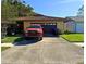 Charming single-story home with a driveway, front yard and a beautiful red Toyota parked at 10223 Marco Polo Dr, Orlando, FL 32821