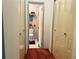 Hallway view of a toilet room featuring a tile floor, toilet, and decorations at 10223 Marco Polo Dr, Orlando, FL 32821