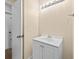 Updated bathroom featuring a white vanity, sink, lighting, and a doorway at 1035 W Minnehaha Ave, Clermont, FL 34711